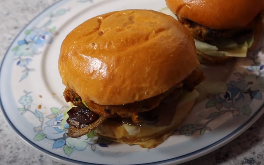 two baked pumpkin burgers on a plate