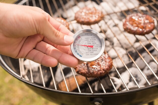 Man using meat thermometer