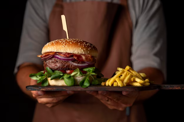 Front view man holding tray with hamburger and fries