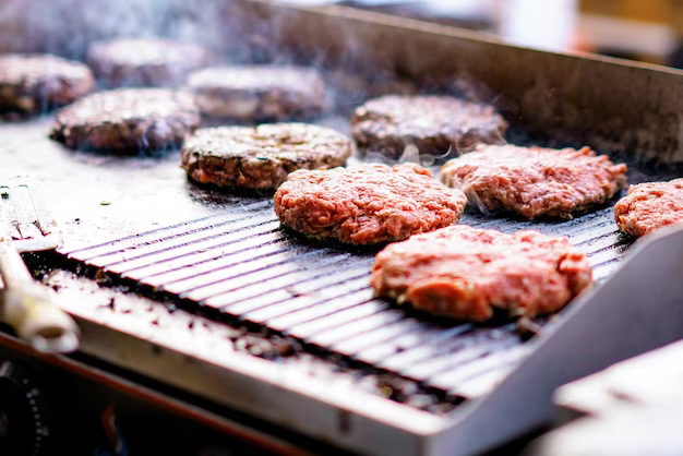 The process of preparing meat patties for grilled burgers