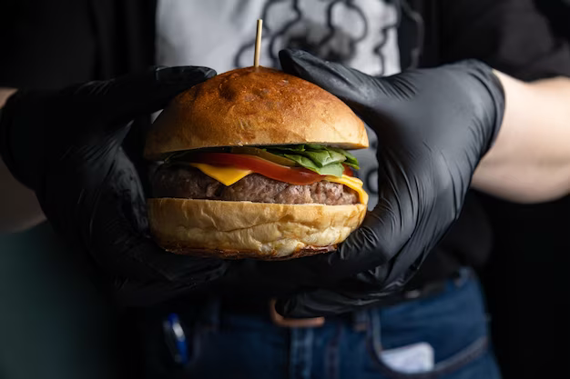 Hands holding a hamburger, front view