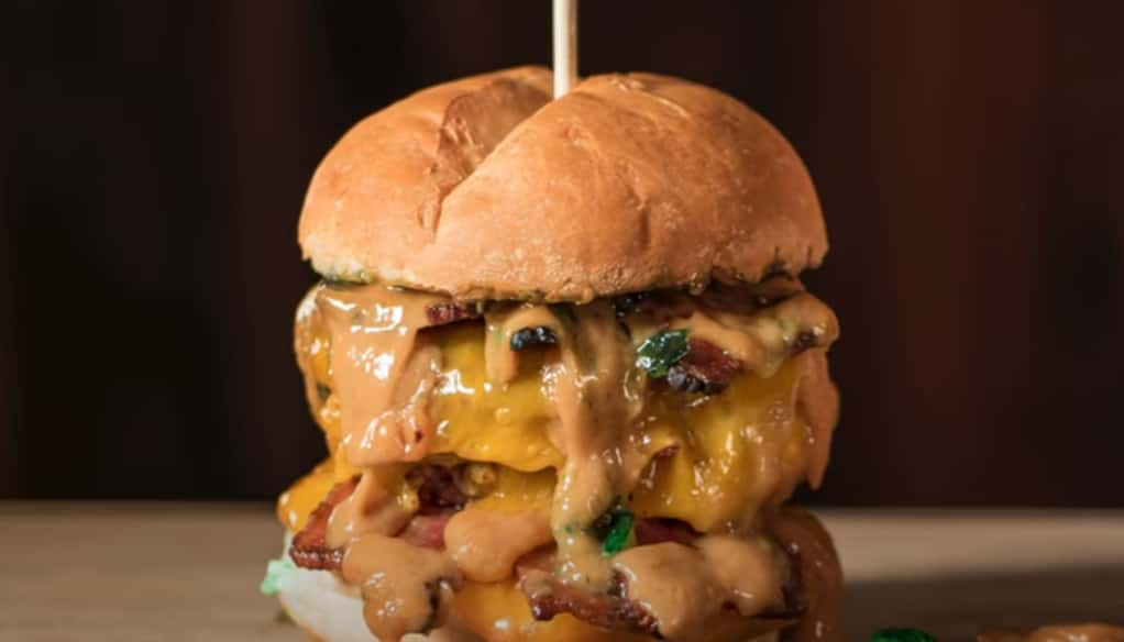 Double cheeseburger oozing with melted cheese and special sauce